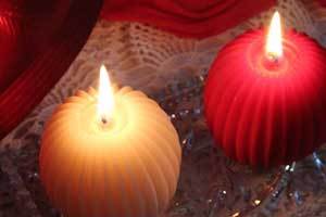 pure beeswax fluted sphere candles on a glass burning plate