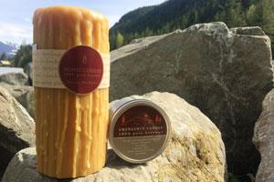 pure beeswax double dipped heritage candle and emergency tin candle on large boulders