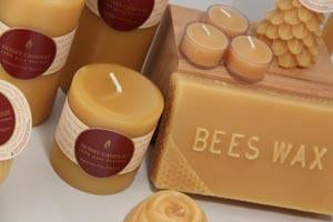 natural beeswax pillar candles and tealight and a block of beeswax