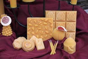 pure beeswax candles and blocks that can be used for natural body care products shown on red linen