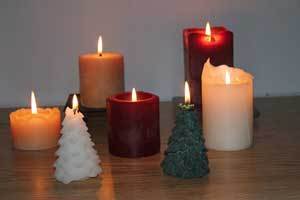 a grouping of pure beeswax pillar candles and tree candles
