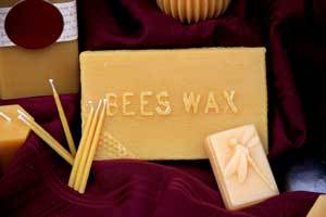 beeswax blocks and gala candles on a red cloth