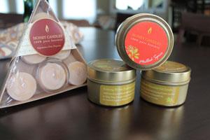 triangle gift pack of beeswax candles and a stack of three of the beeswax essential candle tins