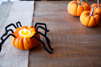 pure beeswax tealight candle in a DIY halloween pumpkin candle holder