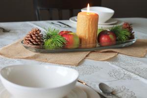 beautiful beeswax heritage candle in a thanksgiving centerpiece with apples and pinecones