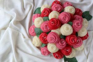 a valentine day bouquet of pure beeswax rose candles in pink , red and white