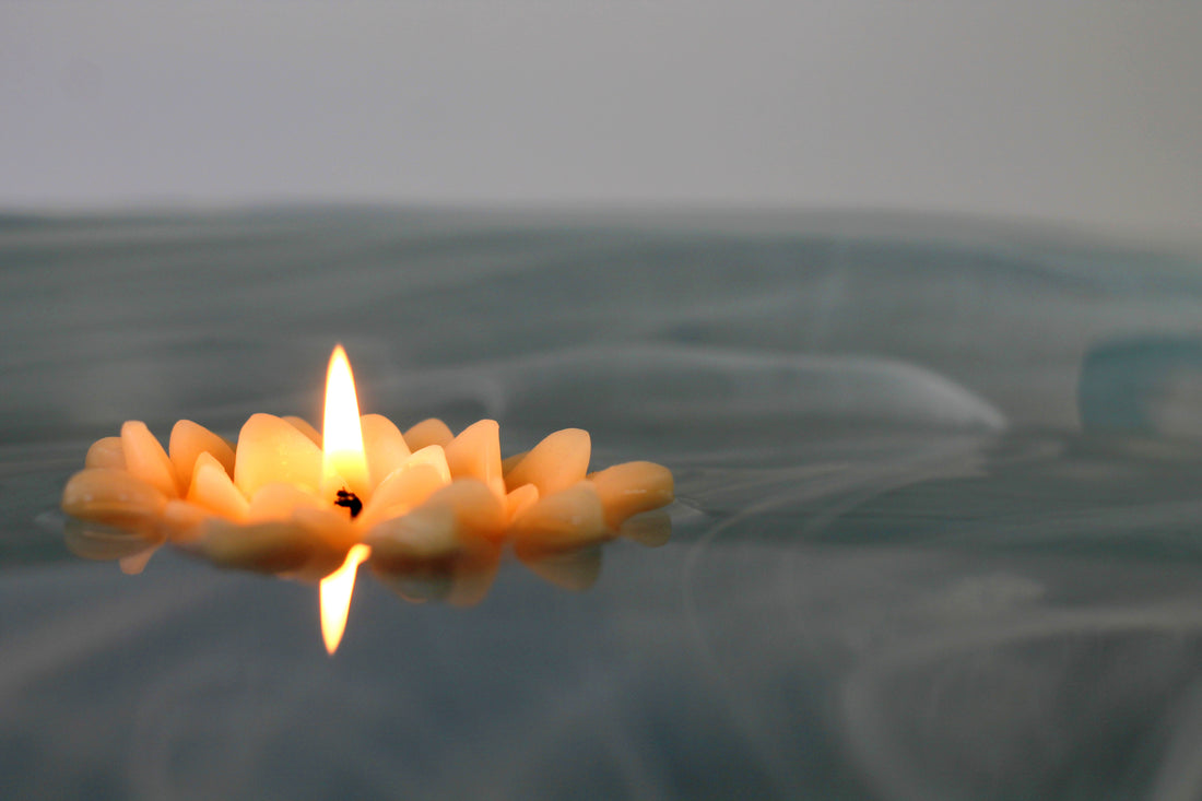 pure beeswax lotus blossom candle floating on water 