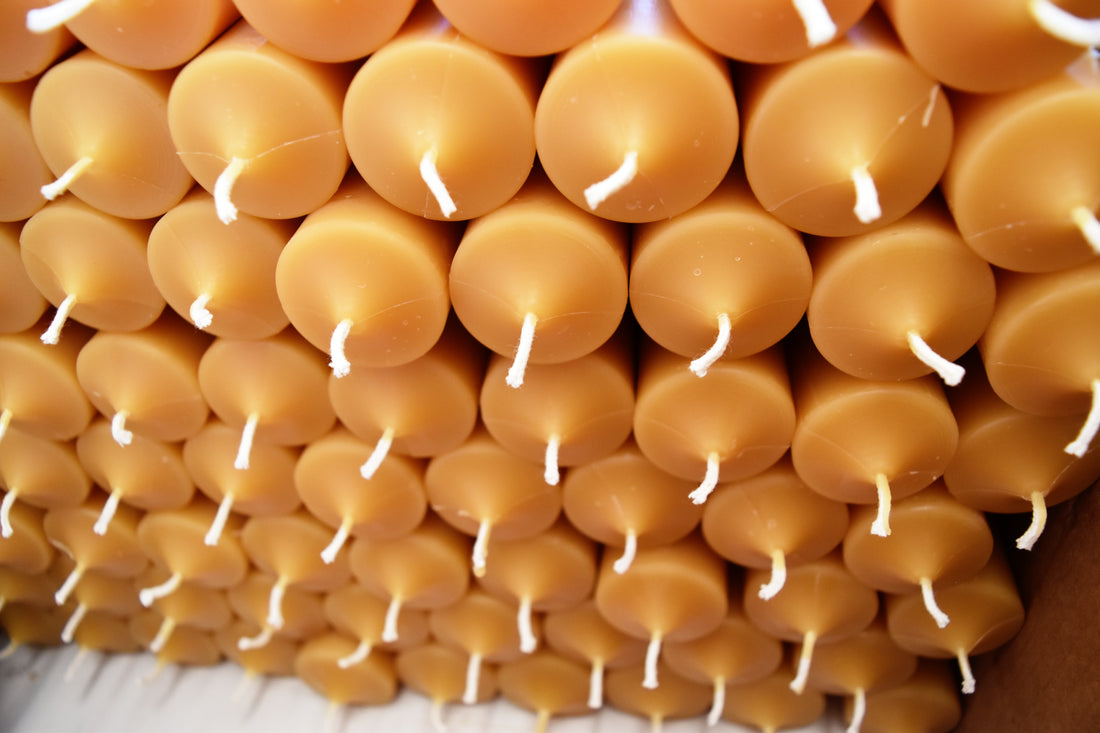 A stack of non toxic bees wax candle sticks 