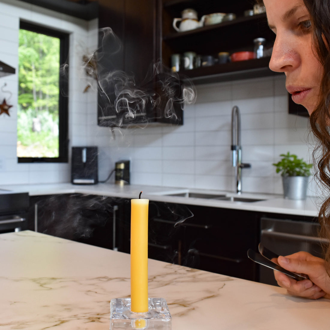 A candle smoking after being blown out. How to extinguish a candle without smoke