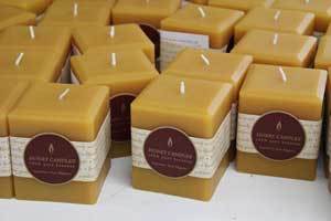 a grouping of natural three inch beeswax pillar candles