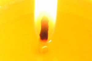 extreme c;lose up photo of a candle flame and the wick