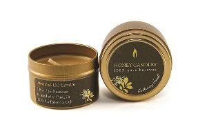 a pure beeswax essential candle in a metal tin