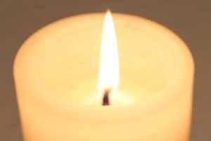 close up view of a perfectly burning wick on a pure beeswax candle