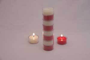 a stack of red and white pure beeswax candles