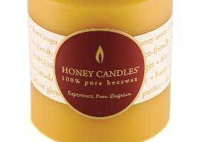 close up photo of the Honey Candles logo wrapped on a natural color pure beeswax pillar candle