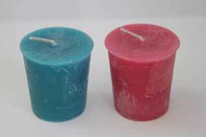 teal and pink beeswax votive candles with a natural occurring bloom