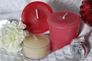 red and white pure beeswax candles on white cloth with white flowers for valentine's day