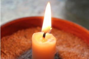 a burning beeswax column candle