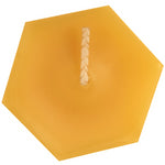 The top of a hexagonal beeswax votive candle and wick, yellow to golden yellow color, with a sweet honey scent.