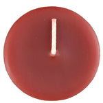 The top of a beeswax votive candle and wick, burgundy in color.