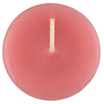 The top of a beeswax votive candle and wick, pink in color.