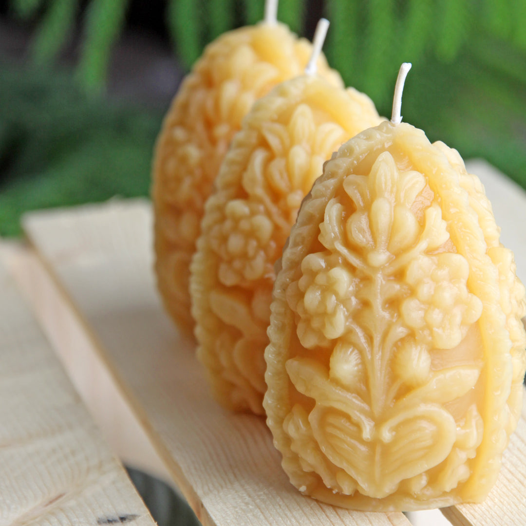 Ornate beeswax egg shaped candles