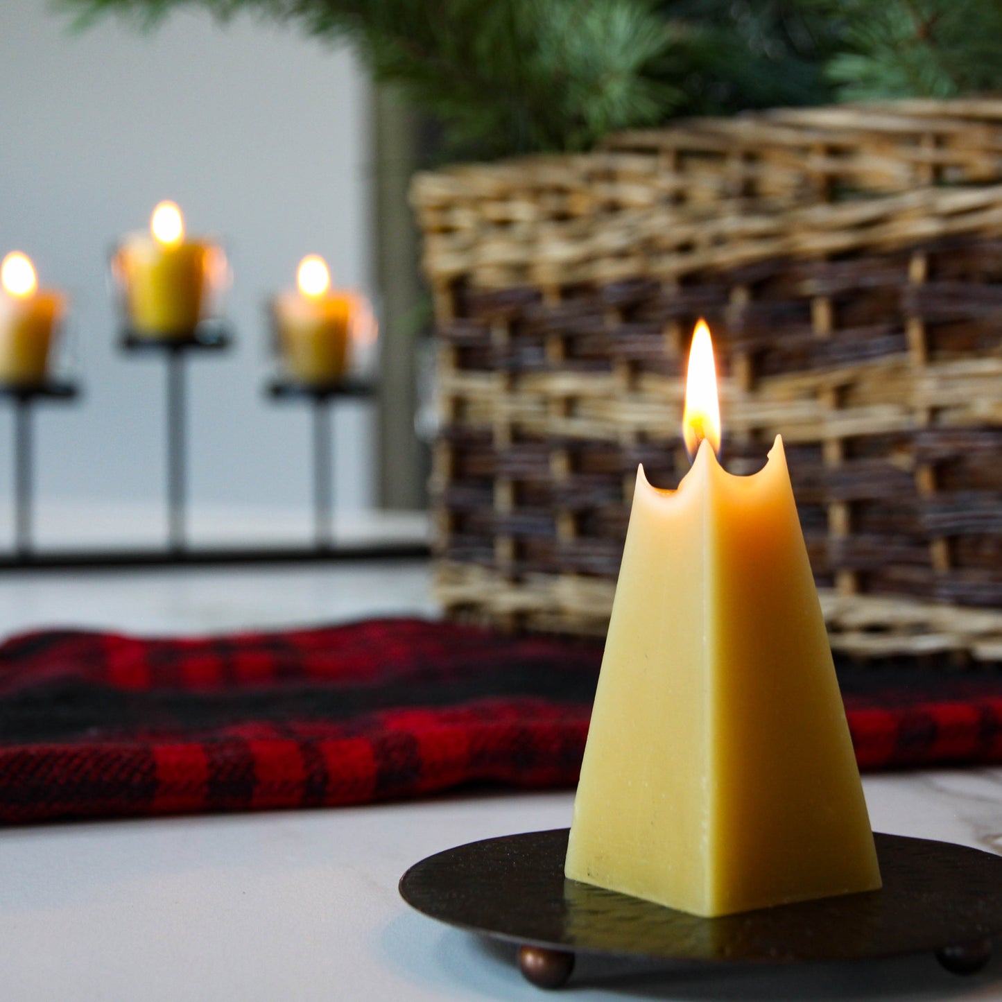 pyramid shaped beeswax candle burning 