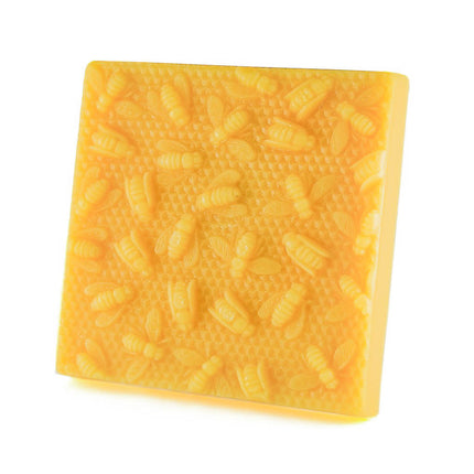 one pound block of natural golden beeswax, with bees on honeycomb.
